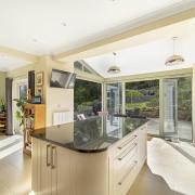 The superbly appointed kitchen has two sets of doors to the garden