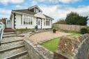 The large bungalow has a good-sized front garden.