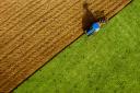 Aerial view of tractor ploughing field, stock image.