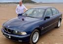 Andrew Scott with his BMW on the beach in Weston