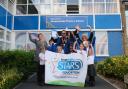 Staff and pupils celebrating their award