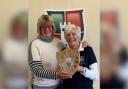 Weston lady captain Jackie Read presenting the shield to her Worlebury counterpart Sarah Tyler