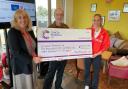 Paul Hobbs, Izzy Thorpe hand over the cheque to Louise Gash.