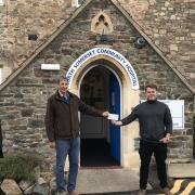 Jonny and Romajo treasurer Kathryn Delve handed over a cheque for more than £5,000 outside the hospital in Clevedon’s Old Street.