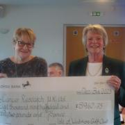 Wedmore Golf Club's Helen Tanswell presents a cheque of £9,000 to Cancer Research.