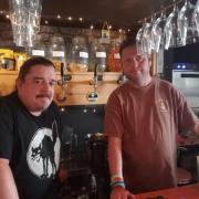 Nick Smith (left) and Alistair Lodge, member of staff, behind the bar