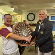 Banwell’s Captain Chris Wilson (left) presenting the shield to a beaming Winscombe Captain Chris Bryant.