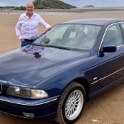 Andrew Scott with his BMW on the beach in Weston