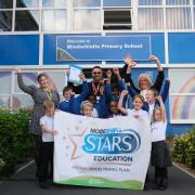 Staff and pupils celebrating their award