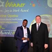 Divine receives his award from Director of Nursing David Wilmott