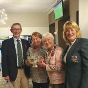 John and Alison Whitewood with Sally Irlam presenting the trophy and lady captain Jackie Read