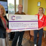 Paul Hobbs, Izzy Thorpe hand over the cheque to Louise Gash.